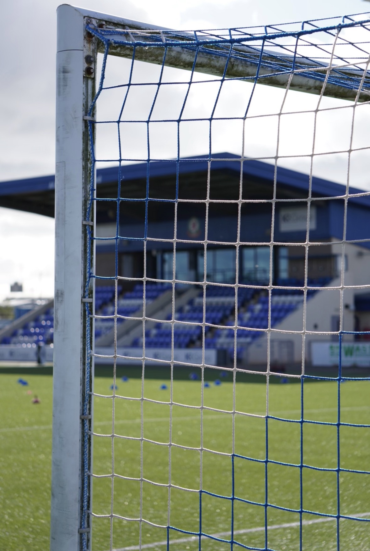 Goalpost and net with the pitch and stand beyond
