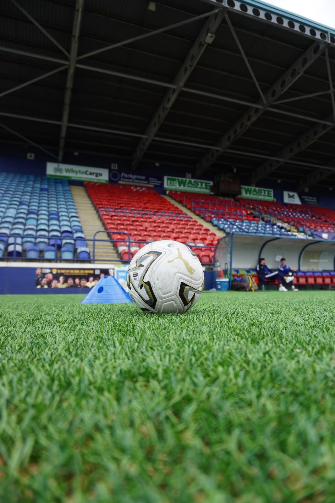Football set on the pitch in front of the stand